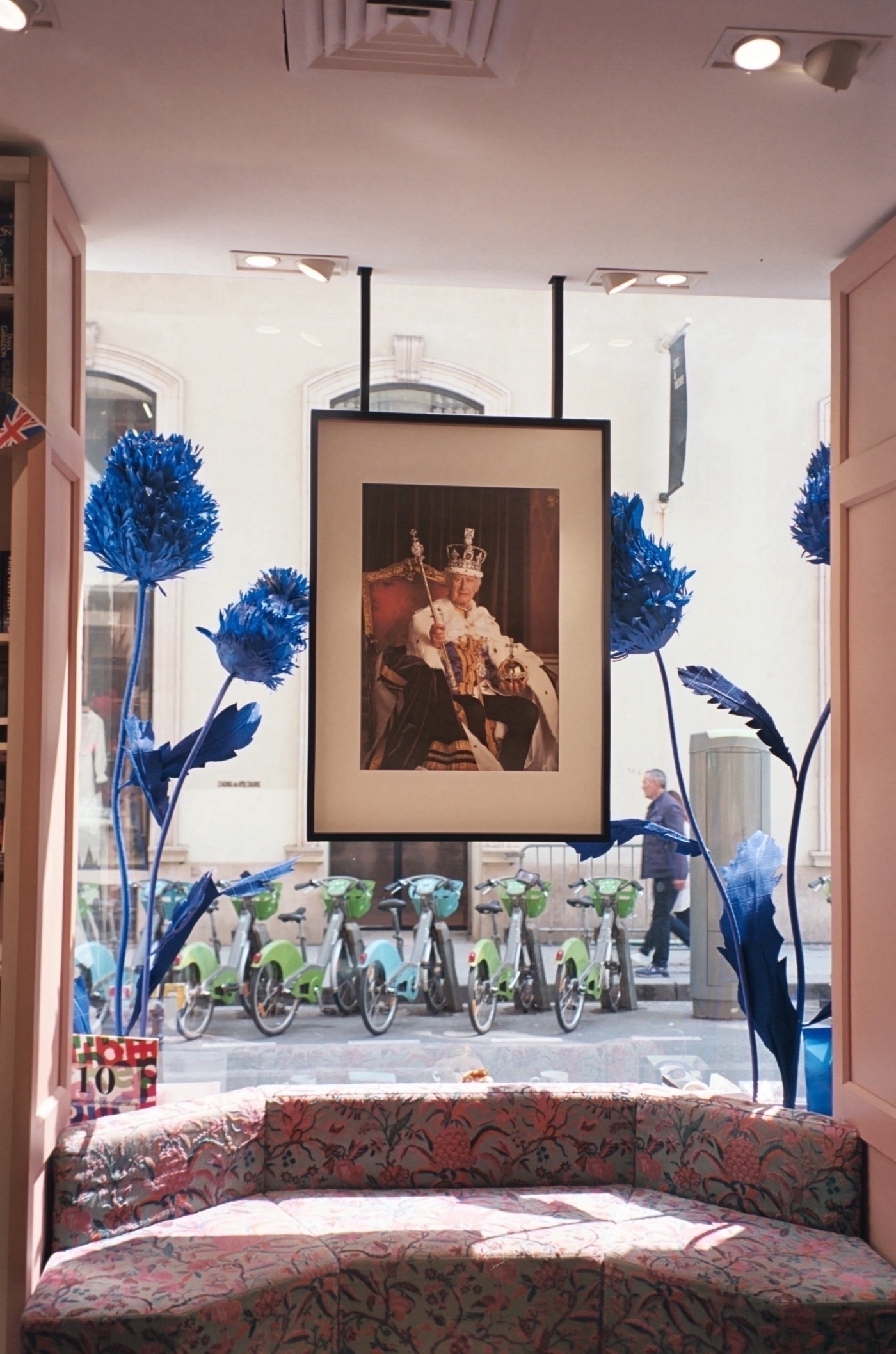 Photo of a photo of The King, hanging in an English bookstore in Paris, May 2023. Photo taken with Leica Z2X in Paris by Josh Withers.